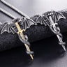 Pictured are two intricately detailed Flying Dragon With Sword Necklaces by Yellow Pandora, each featuring a dragon with outstretched wings coiled around a sword. One necklace has a golden sword while the other features a silver one, both complemented by textured chains. The Alloy Necklaces rest on a dark surface.