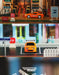 A series of three stacked images featuring a Turbo Racing 1:76 Miniature Full-Scale C71c72c73c74 Remote Control Electric Drift Sports Car Toy from Lacatang Shop in orange. The top image shows the car at a gas station, the middle image has it parked on a street with two bicycles in the background, and the bottom image displays the TURBO RACING logo.