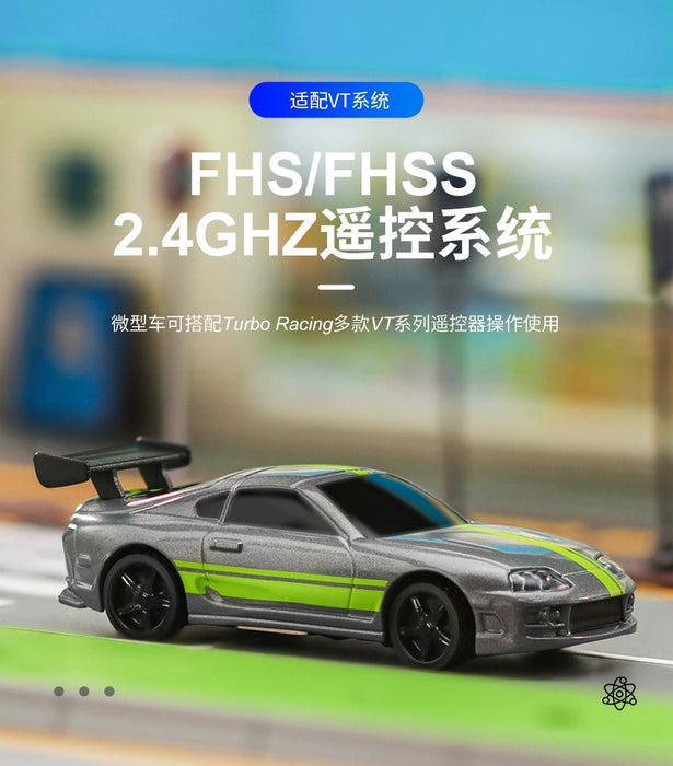 On display is the Turbo1/76 Miniature RC Remote Control Electric Sports Car from Lacatang Shop, featuring a silver body with green stripes and a black spoiler, set against a blurred background. The image also includes Chinese text that refers to the FHS/FHSS 2.4GHz remote control system and TURBO RACING series.