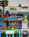 A detailed diorama of a city street with toy cars and structures. The top section showcases a road with a green electric sports car from Lacatang Shop and a purple Turbo1/76 Miniature RC Remote Control Electric Sports Car. The middle section displays a parking lot with signs and a yellow car. The bottom section features a toll booth with another Turbo1/76 Miniature RC Remote Control Electric Sports Car in green and black, complete with an RC remote control for enhanced simulation.