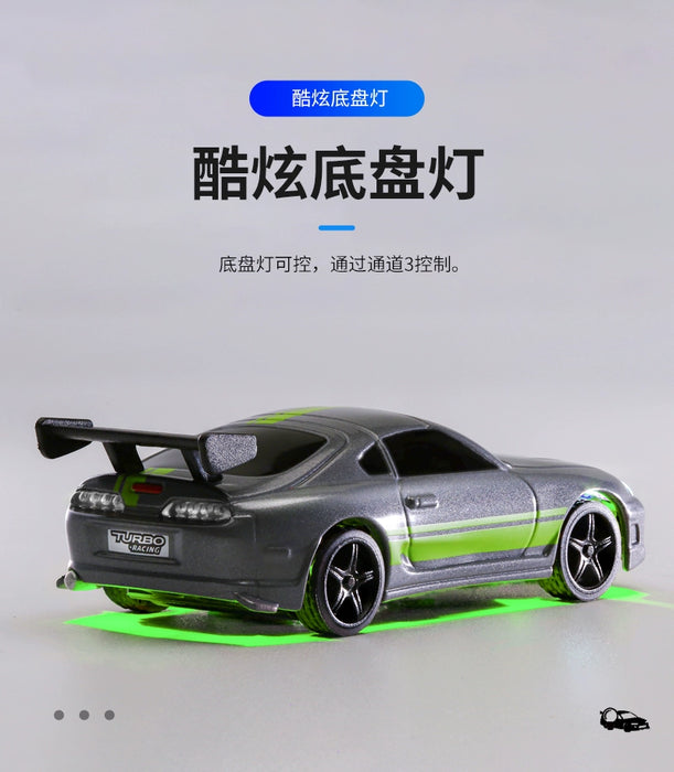 A small, silver Turbo1/76 Miniature RC Remote Control Electric Sports Car by Lacatang Shop, modeled after a Toyota with a rear spoiler and green underglow lights, is shown. The micro RC features detailed black rims and decals on the back. Chinese text is visible in the background.