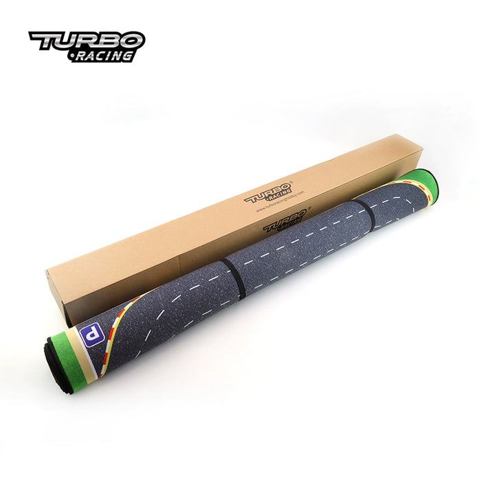 The Turbo Remote Control Drift Car Track from Lacatang Shop is a rolled-up mat with roads, green borders, and parking symbols. It's perfectly paired with the "Turbo Racing" box for thrilling drift racing sessions.