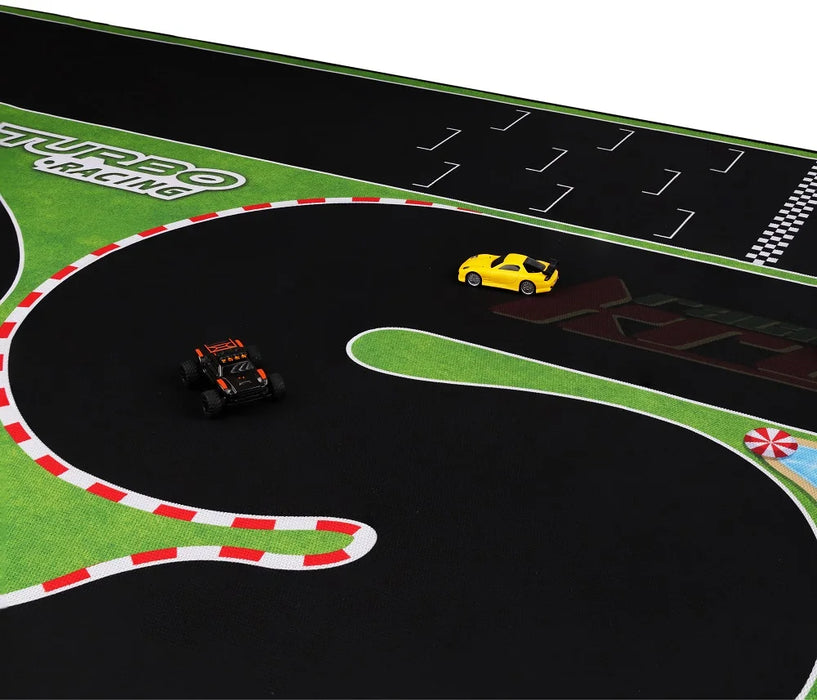 The Lacatang Shop Turbo Racing Portable PVC Race Track Mat (1.6m x 0.9m) for mini RC cars features a winding roadway with start/finish line, green areas, and red-and-white striped borders, complete with a black car and a yellow car positioned on it.