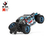 A remote-controlled off-road car with a rugged black and blue design, featuring large, chunky tires and bold graphics. Powered by a high-capacity lithium battery, it can reach speeds of up to 30KM/H. The Lacatang Shop logo is visible in the top left corner as the WLtoys 1:28 284131 284161 2.4G Racing Mini RC Car performs a stunt on two wheels.