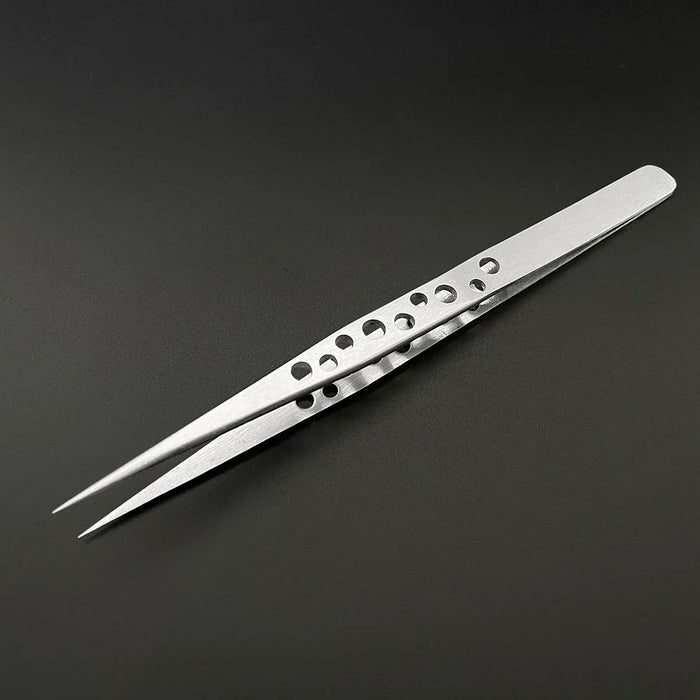 A pair of AliExpress Industrial Tweezers Electronics Anti-static with curved straight tips and small circular holes in the handle, lying on a black background. These silver tweezers are free from any black marks and feature sharp, pointed tips suitable for detailed work.