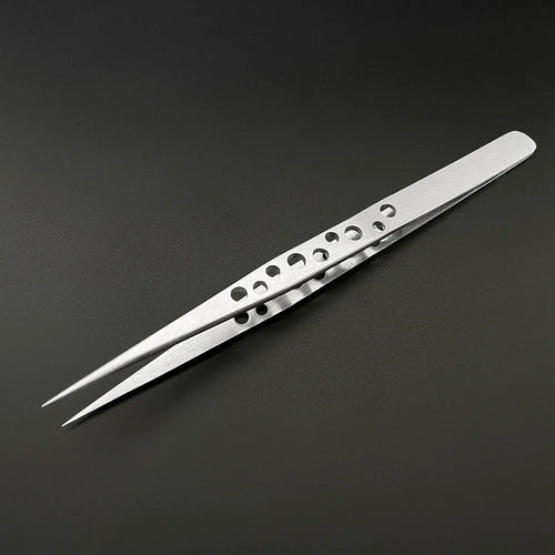 A pair of Industrial Tweezers Electronics Anti-static Curved Straight Tip by AliExpress, designed with a sleek aesthetic and featuring small circular holes in the gripping area, lying on a smooth black surface. The tweezers boast pointed tips and a matte finish that resists black marks while maintaining their polish.