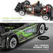 Two close-up images of parts of the WLtoys 1:28 284131 284161 Racing Mini RC Car by Lacatang Shop. The top image features the car's internal steering mechanism, with text highlighting its digital steering gear. The bottom image showcases the all-terrain rubber tires, various decals with "FORCE" branding, and emphasizes its impressive 30KM/H speed powered by a lithium battery.