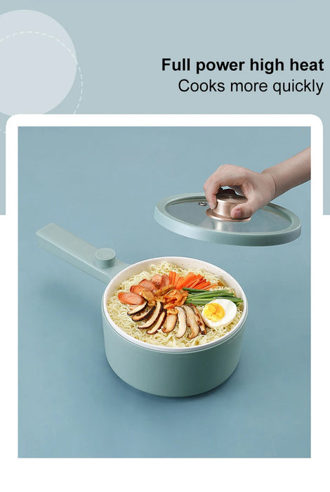 A hand lifting the lid off a light green 2024 New Portable 1.5L Multi-function Pot Rice Cooker Electric Cooking Stir Frying Noodle Pot Mini Hot Pot Household Dormitory by Lacatang Shop, containing a colorful meal of noodles, sliced carrots, mushrooms, green vegetables, and a halved boiled egg. The text on the image reads, "Full power high heat. Cooks more quickly.