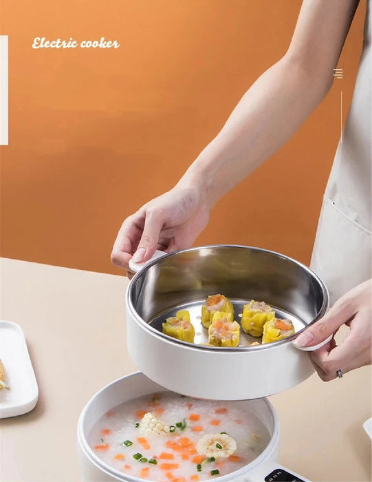 A person wearing a beige apron holds a round metal tray filled with dim sum over the Lacatang Shop 1.6L Smart Electric Cooking Pot Reservation Multifunctional Non-stick Electric Wok Household Electric Hot Pot With Steamer 220V. The hot pot also contains a bowl of soup with small diced vegetables, garnished with green onions. An orange background frames the scene. Text reads "Electric cooker.