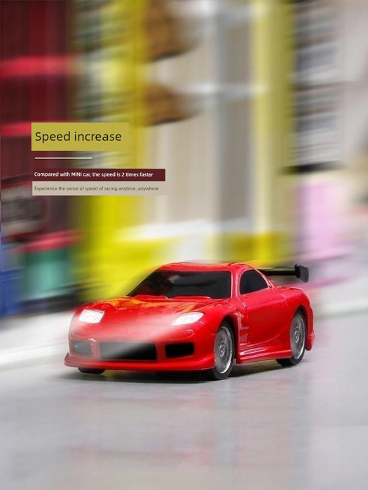 A red JDM Racing Miniature Toy Remote Control Sports Car with a black spoiler from Lacatang Shop speeds along a blurred, colorful background. Text overlays the image, stating, "Speed increase compared with MINI car, the speed is 2 times faster. Experience the sense of speed of racing anytime, anywhere.