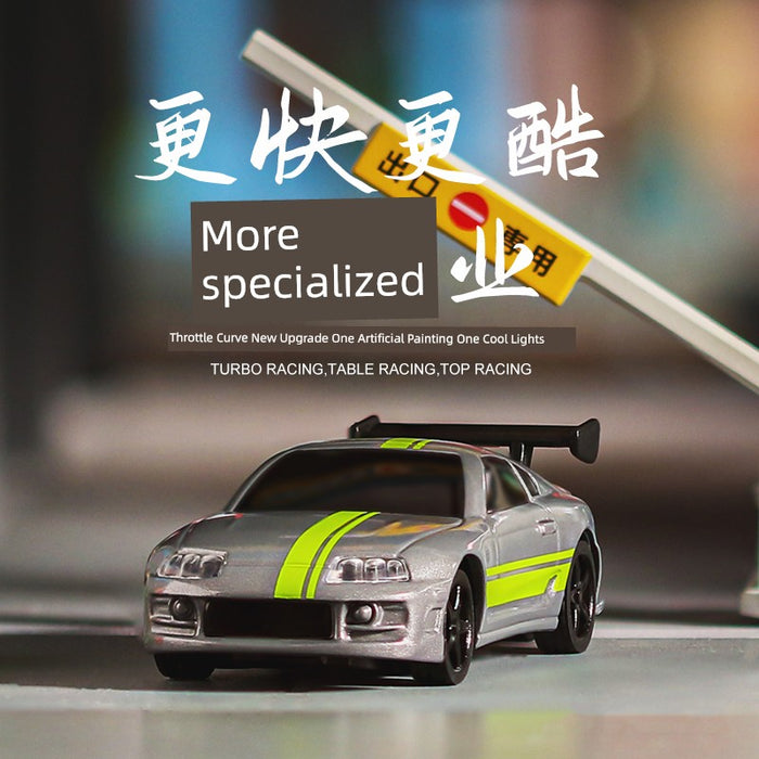 A toy silver electric sports car with neon green stripes is displayed prominently. Behind it, a blurred road sign with Chinese characters is visible. Text overlays the image, saying "More specialized" and "Turbo Racing, Table Racing, Top Racing." This miniature marvel is none other than the Turbo Racing 1:76 Miniature Full-Scale C71c72c73c74 Remote Control Electric Drift Sports Car Toy from Lacatang Shop.