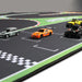 Lacatang Shop's Portable Turbo Racing Rubber Track Mat (160x90cm & 180x80cm) features a realistic black surface with white outlines and green edges. A checkered finish line awaits a green Mini Cooper, red-orange Nissan, yellow jeep, and black off-roader with enhanced grip in separate lanes.