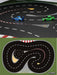 A toy racetrack set from Lacatang Shop features the Turbo Racing 1:76 RC cars on a black track with red and white borders. The top image shows blue and green remote control cars, while the bottom showcases a winding layout perfect for drift track action, complete with jump and cement block mat.