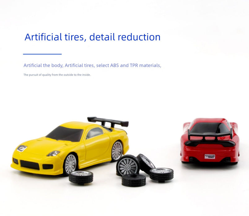 Two miniature remote control sports cars from Lacatang Shop's JDM Racing collection, one yellow and one red, are displayed on a white surface. Several small tires are scattered in front of these cars. The text above the image reads “Turbo Racing tires, detail reduction," emphasizing the high-quality materials used for these realistic toys.