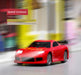 A JDM Racing Miniature Toy Remote Control Sports Car from Lacatang Shop is captured in motion, generating a blurred background effect. The text "Speed increase" hovers above the car, with additional text revealing that this Turbo.Racing toy is 2 times faster than a MINI car. The scene is set in a bright indoor environment with a colorful, out-of-focus backdrop.