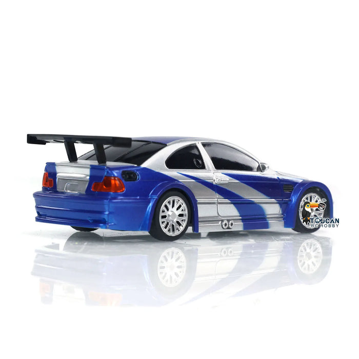 A blue and white remote-controlled toy car with a large rear spoiler is shown against a white background. The sleek 1/43 RC Mini Race Car boasts sporty lines, silver rims, and detailed body accents. Branded with the "Lacatang Shop" logo on the lower right side, this 2.4g Radio Control Drift Car TH23884 promises endless fun for boys as a high-speed model toy.