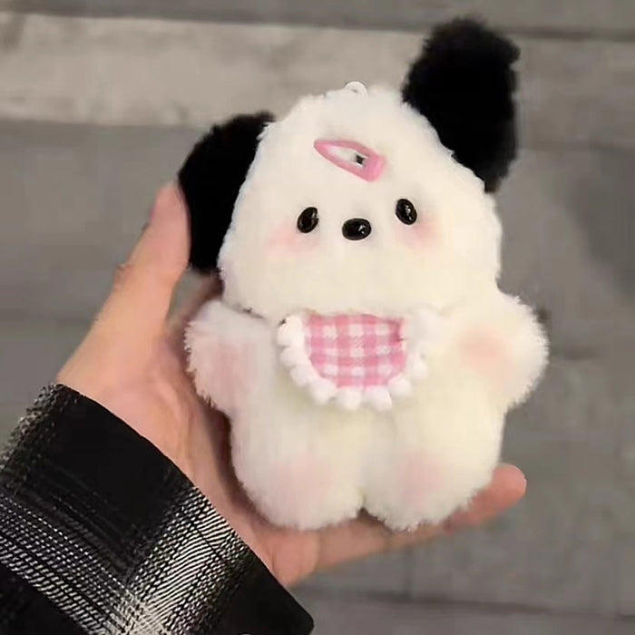 A hand holds an Adorable Plush Puppy Keychain from Lacatang Shop—a cute, fluffy white animal with black ears, small black eyes, and a pink nose. It sports a pink and white checkered bib with a pink bow on its head, perfect as a bag charm for women and girls. Ideal birthday gift.