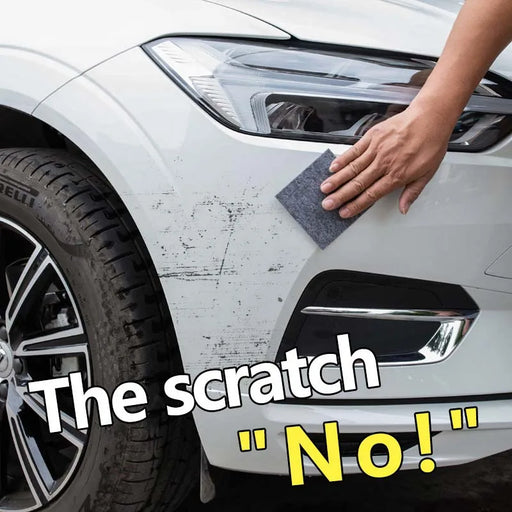 A hand is seen attempting to remove scratches from the front bumper of a white car using a cleaning pad. Text overlaid on the image reads, "The scratch 'No!'", indicating that the method being used is not suitable compared to AliExpress' Nano Sparkle Cloth Car Scratch Repair Accessories Multifunction Nano for effective car scratch removal.