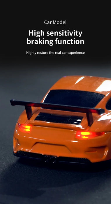 A close-up of a miniature 1/43 scale orange sports car model with a prominent rear spoiler. The text above reads, "Lacatang Shop: High sensitivity braking function - Highly restore the real car experience." The 1/43 RC Car Mini Racing Cars 2.4G Radio Control Drift Car is photographed on a dark surface with a gradient background.