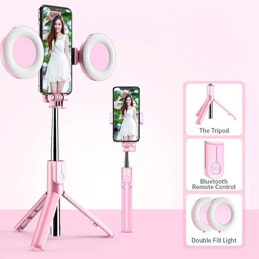 A pink 4In1 Wireless Bluetooth Compatible Selfie Stick LED Ring Light Extendable Handheld Monopod Live Tripod by Lacatang Electronics secures a smartphone for optimal photographic lighting. Nearby, the phone is showcased vertically in an adjustable holder. The image features essential accessories: the Tripod, Detachable Wireless Remote Control, and Double Fill Light.