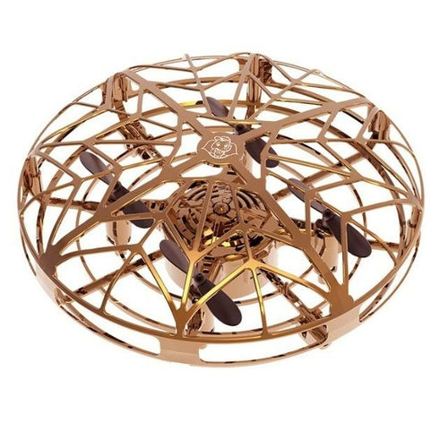 The Jade Flying Helicopter Mini Drone UFO RC Drone Infrared Induction Aircraft features a circular golden design with a cage-like exterior. Its intricately crafted web-like patterns safeguard the black propellers inside, making it ideal for beginners. This drone includes a wireless remote control and offers top-notch service for a seamless flying experience.